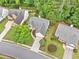 An aerial view of a home in a neighborhood with mature trees and well-kept lawns at 554 Grand Ashbury Ln, Sugar Hill, GA 30518