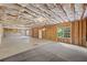 Unfinished basement with exposed insulation, framed walls, concrete floors, and a window at 554 Grand Ashbury Ln, Sugar Hill, GA 30518