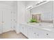 Bathroom with dual sinks, white vanity, tub, walk-in shower and neutral tile floors at 554 Grand Ashbury Ln, Sugar Hill, GA 30518