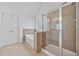Bathroom featuring a walk-in shower, garden tub, tile floors and double door entry at 554 Grand Ashbury Ln, Sugar Hill, GA 30518