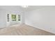 Bright and airy bedroom with large windows and neutral carpet at 554 Grand Ashbury Ln, Sugar Hill, GA 30518