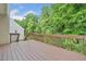 Exterior deck overlooks lush greenery with wood railing providing a tranquil outdoor space at 554 Grand Ashbury Ln, Sugar Hill, GA 30518