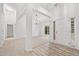 Bright, airy foyer with wood flooring, carpet and decorative trim at 554 Grand Ashbury Ln, Sugar Hill, GA 30518
