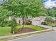 Lovely front exterior featuring manicured lawn, landscaping, and a brick facade at 554 Grand Ashbury Ln, Sugar Hill, GA 30518