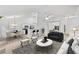 Open-concept living space with white walls, and views into the kitchen and dining area at 554 Grand Ashbury Ln, Sugar Hill, GA 30518