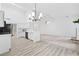 Open floor plan showing kitchen with breakfast bar, dining area, and living room at 554 Grand Ashbury Ln, Sugar Hill, GA 30518