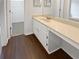 Bright bathroom featuring a white vanity and cabinets, wood floor, and a walk-in closet at 688 Anderson Walk, Marietta, GA 30062