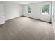 Bedroom featuring plush neutral carpet, two windows, and a crisp, bright ambiance at 688 Anderson Walk, Marietta, GA 30062