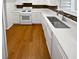Bright kitchen features white cabinets, sleek countertops, and stainless steel sink at 688 Anderson Walk, Marietta, GA 30062