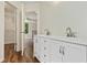 Bright bathroom featuring a double vanity, and a view into the main bedroom and walk-in closet at 179 Oakville Dr, Dallas, GA 30157