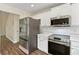 Bright kitchen with stainless steel appliances and white cabinets at 179 Oakville Dr, Dallas, GA 30157