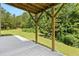 Covered patio featuring natural wood supports overlooking the expansive backyard at 179 Oakville Dr, Dallas, GA 30157