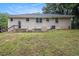 Backyard view of a home with grass and a patio area; with brick lattice at 1955 Vicki Se Ln, Atlanta, GA 30316