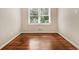 Bright bedroom with hardwood floors and a large window at 1955 Vicki Se Ln, Atlanta, GA 30316