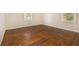 Spacious bedroom with hardwood floors and two windows providing natural light at 1955 Vicki Se Ln, Atlanta, GA 30316