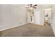 Bedroom featuring neutral carpet, wood paneling, ceiling fan and an en-suite bathroom at 1955 Vicki Se Ln, Atlanta, GA 30316