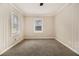 Comfortable bedroom with neutral carpet, wood paneling and two windows at 1955 Vicki Se Ln, Atlanta, GA 30316