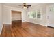 Open living room with hardwood floors, view of the dining area and a sunlit window at 1955 Vicki Se Ln, Atlanta, GA 30316
