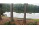 Scenic view of the lake with bench seating nestled among the trees, offering a peaceful retreat at 2435 Northlake Ct, Atlanta, GA 30345