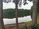 Scenic lake view framed by trees and a bench, offering a serene spot for relaxation and enjoying nature at 2435 Northlake Ct, Atlanta, GA 30345