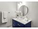 This bathroom features a modern vanity with gold hardware, a round mirror, and fresh white towels at 2435 Northlake Ct, Atlanta, GA 30345