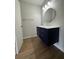 Modern bathroom vanity with drawers and a circular mirror at 2435 Northlake Ct, Atlanta, GA 30345