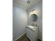 Modern bathroom featuring a granite countertop and a stylish round mirror at 2435 Northlake Ct, Atlanta, GA 30345