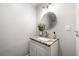 Updated half bathroom with granite countertops, white vanity, modern fixtures and neutral paint at 2435 Northlake Ct, Atlanta, GA 30345
