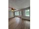 Bright bedroom featuring hardwood floors and bay windows overlooking a lake at 2435 Northlake Ct, Atlanta, GA 30345