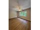 Bright bedroom with hardwood floors, ceiling fan, and a wall of windows at 2435 Northlake Ct, Atlanta, GA 30345