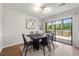 Bright dining room features a modern chandelier, a square table with six chairs, and access to a deck with a beautiful lake view at 2435 Northlake Ct, Atlanta, GA 30345