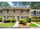 Charming brick townhouse with manicured landscaping and classic black shutters on the windows at 2435 Northlake Ct, Atlanta, GA 30345