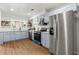 Renovated kitchen featuring stainless steel appliances, blue cabinets, quartz countertops, and hardwood floors at 2435 Northlake Ct, Atlanta, GA 30345