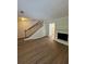 Open living room with a classic fireplace, wooden staircase and laminate floors at 2435 Northlake Ct, Atlanta, GA 30345