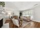 Open living room features a cozy fireplace, hardwood floors, neutral colors, and lots of sunlight at 2435 Northlake Ct, Atlanta, GA 30345
