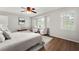 Bright main bedroom with big windows with shutters, ceiling fan and two sitting chairs at 2435 Northlake Ct, Atlanta, GA 30345
