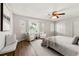 Bright main bedroom with big windows with shutters, ceiling fan, and two sitting chairs at 2435 Northlake Ct, Atlanta, GA 30345