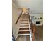 View of staircase with hardwood treads and white risers leading to an open floor plan with a fireplace in the living room at 2435 Northlake Ct, Atlanta, GA 30345