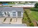 Attractive aerial view of the townhome's grey roof, driveways, and green landscaping at 2808 Maddison Towns Ave, Norcross, GA 30071