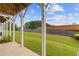 Charming back porch featuring green lawn area, and beautiful trees in the horizon at 2808 Maddison Towns Ave, Norcross, GA 30071