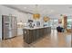 Modern kitchen with stainless steel appliances, a large island with bar seating, and decorative pendant lighting at 2808 Maddison Towns Ave, Norcross, GA 30071