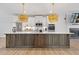 Spacious kitchen with quartz counters, stainless steel appliances and unique pendant lights above large kitchen island at 2808 Maddison Towns Ave, Norcross, GA 30071
