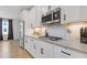 Close-up of the kitchen's stainless steel appliances, white cabinetry, and sleek countertops at 2808 Maddison Towns Ave, Norcross, GA 30071