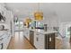 Bright, white kitchen with large center island, stainless appliances and hardwood floors at 2808 Maddison Towns Ave, Norcross, GA 30071