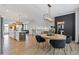 Bright, open-concept living and dining area features modern lighting, wood floors, and a decorative wall panel at 2808 Maddison Towns Ave, Norcross, GA 30071