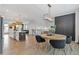 Bright, open-concept living and dining area features modern lighting, wood floors, and a decorative wall panel at 2808 Maddison Towns Ave, Norcross, GA 30071