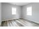 Bright bedroom with wood-look floors and two windows, featuring neutral paint at 3175 Dogwood Dr, Atlanta, GA 30354