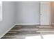 Bedroom with wood-look flooring, neutral gray paint, and a white interior door at 3175 Dogwood Dr, Atlanta, GA 30354