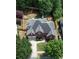 A high angle of a home with a large roof, a driveway and a fence surrounding the backyard at 4046 Creekview Ridge Dr, Buford, GA 30518