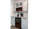 A stylish bar area features gray cabinets, a wine rack, and a beverage fridge for sophisticated entertaining at 4046 Creekview Ridge Dr, Buford, GA 30518